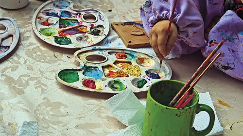 Children painting pottery at a workshop organized by the International Children's Day in Timisoara, Romania.