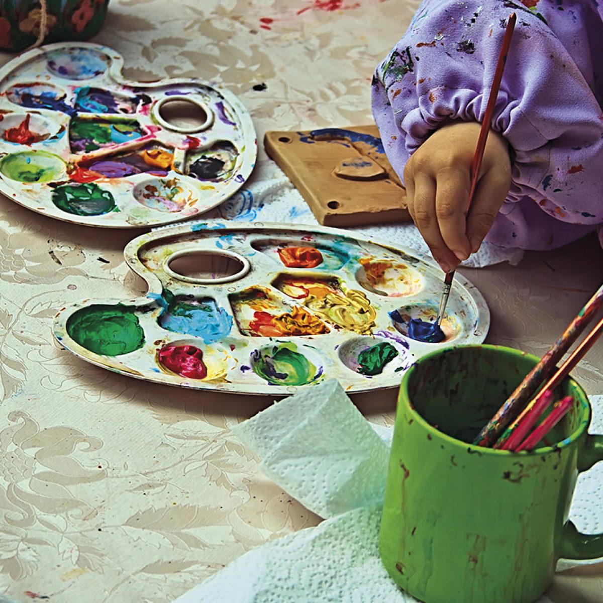 Children painting pottery at a workshop organized by the International Children's Day in Timisoara, Romania.