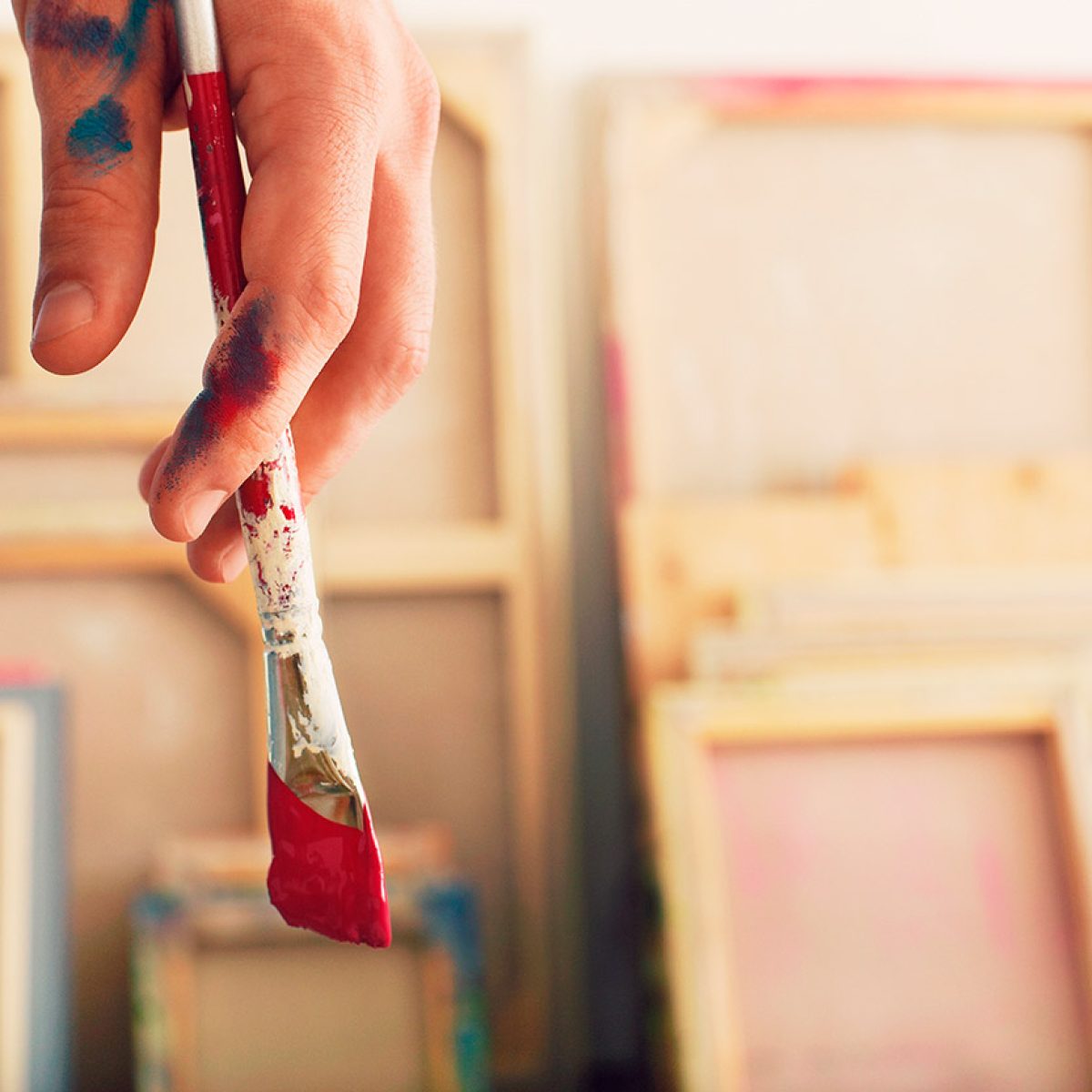 Closeup of an artist holding paintbrush
