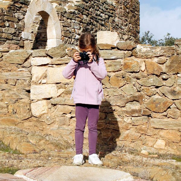 Young girl taking photos inside a castle